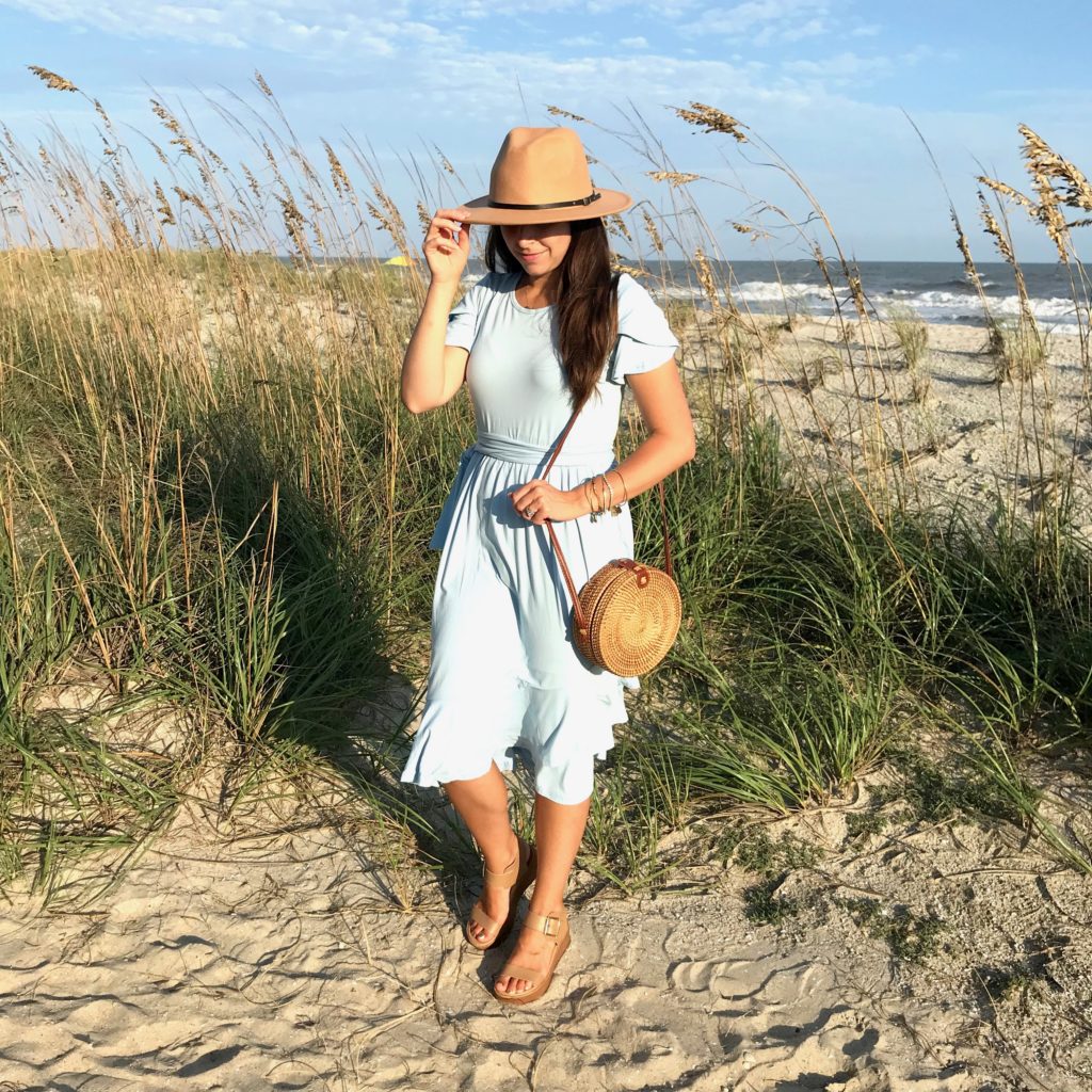 Blue dress, hat, and summer purse.